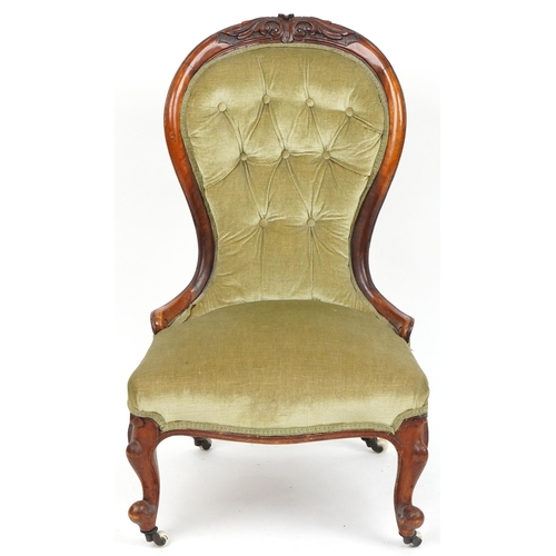 1112 - Victorian carved walnut spoon back nursing chair with green button back upholstered back, 94cm high