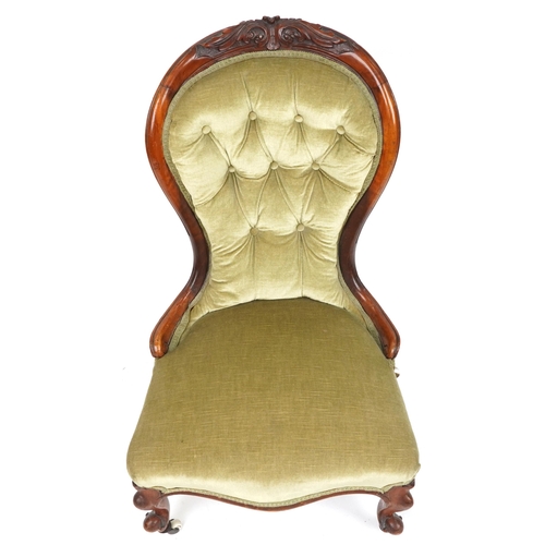 1112 - Victorian carved walnut spoon back nursing chair with green button back upholstered back, 94cm high