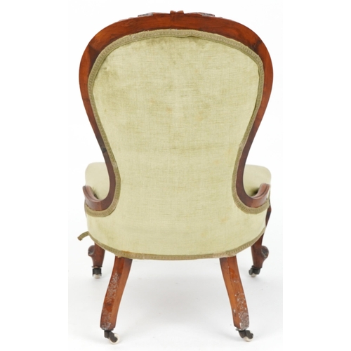 1112 - Victorian carved walnut spoon back nursing chair with green button back upholstered back, 94cm high