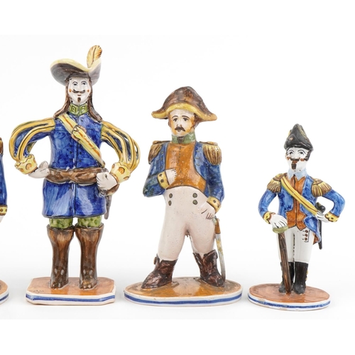 1604 - Set of five continental faience glazed figures of soldiers in uniform, the largest 28cm high