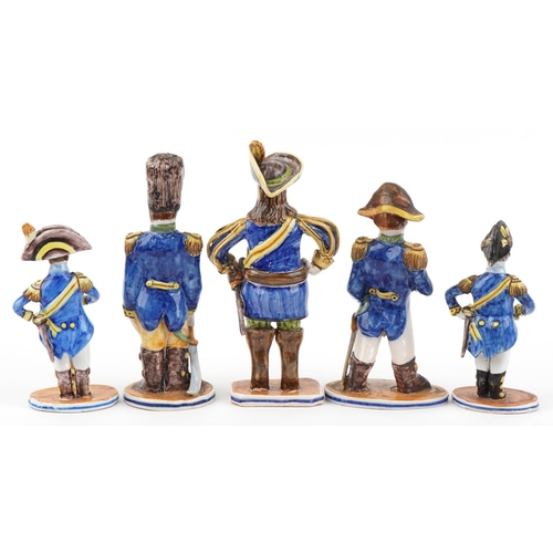 1604 - Set of five continental faience glazed figures of soldiers in uniform, the largest 28cm high