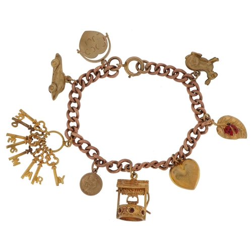 2123 - 9ct gold charm bracelet with eight 9ct gold charms including bunch of keys, wishing well, enamelled ... 