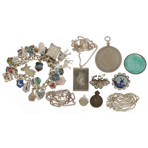 2587 - Silver jewellery including a charm bracelet with enamelled souvenir shields, Elizabeth II Silver Jub... 