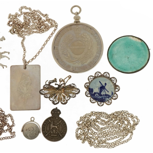 2587 - Silver jewellery including a charm bracelet with enamelled souvenir shields, Elizabeth II Silver Jub... 