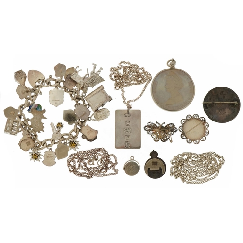 2587 - Silver jewellery including a charm bracelet with enamelled souvenir shields, Elizabeth II Silver Jub... 