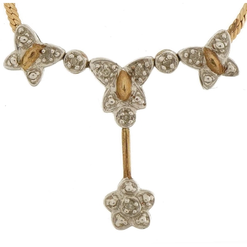 2058 - 9ct gold diamond butterfly and flower head necklace housed in an Ernest Jones fitted box, 40cm in le... 