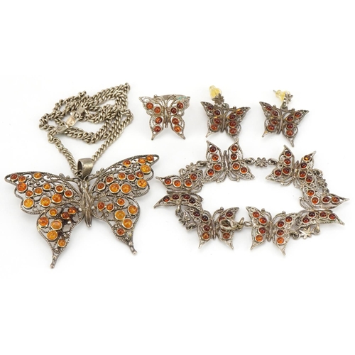 2589 - Silver and amber butterfly jewellery suite comprising pendant on chain, bracelet, pair of earrings a... 