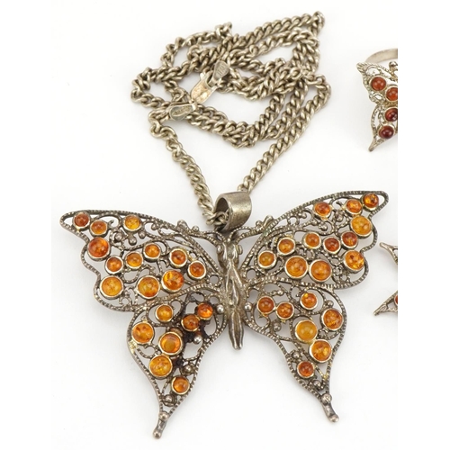 2589 - Silver and amber butterfly jewellery suite comprising pendant on chain, bracelet, pair of earrings a... 