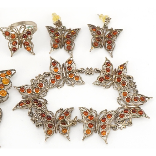 2589 - Silver and amber butterfly jewellery suite comprising pendant on chain, bracelet, pair of earrings a... 