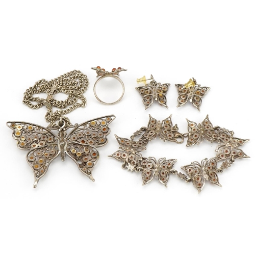 2589 - Silver and amber butterfly jewellery suite comprising pendant on chain, bracelet, pair of earrings a... 