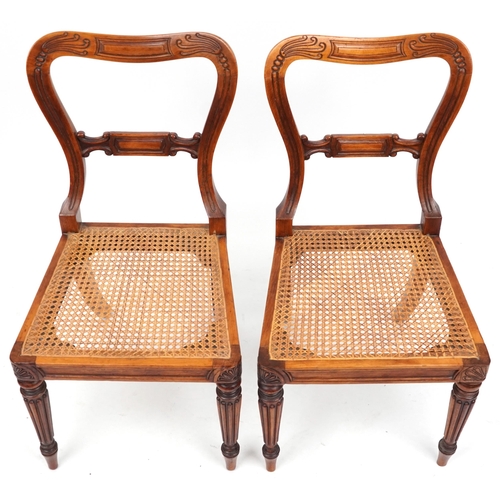 1097 - Pair of Edwardian walnut hall chairs with cane seats, 83cm high