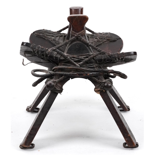 1070 - Afghan hardwood camel saddle stool, 57cm in length