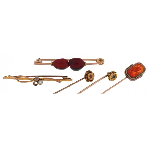 2111 - Antique and later gold and yellow metal stickpins and brooches including one set with diamonds and s... 