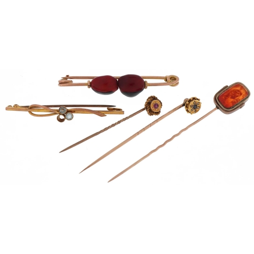 2111 - Antique and later gold and yellow metal stickpins and brooches including one set with diamonds and s... 