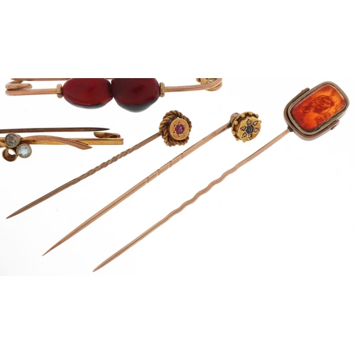 2111 - Antique and later gold and yellow metal stickpins and brooches including one set with diamonds and s... 