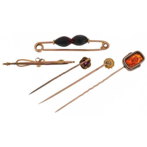 2111 - Antique and later gold and yellow metal stickpins and brooches including one set with diamonds and s... 