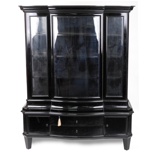 1057 - 19th century European ebonised bow front display cabinet with bevelled glass panels, on tapering leg... 