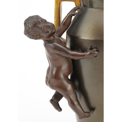 407 - Aesthetic style bronzed vase with twin handles surmounted with a nude bronze child, 16cm high