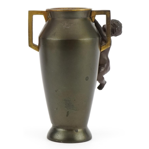 407 - Aesthetic style bronzed vase with twin handles surmounted with a nude bronze child, 16cm high