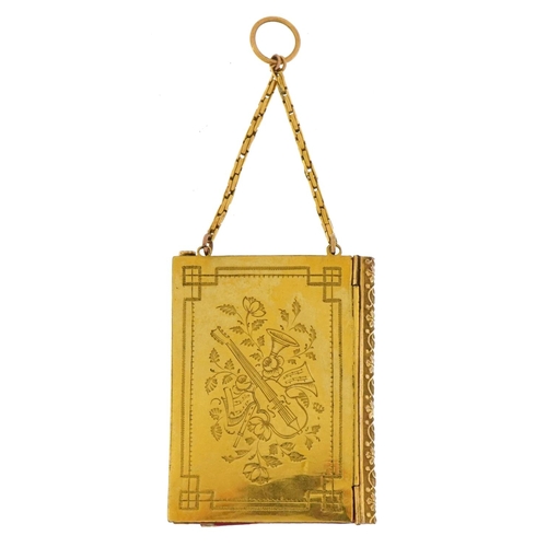 296 - 19th century French gilt metal aide memoire engraved with instruments amongst flowers, 5.5cm high