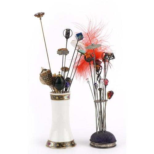 172 - Early 20th century and later hatpins, some silver, together with two hatpin stands, one silver, the ... 