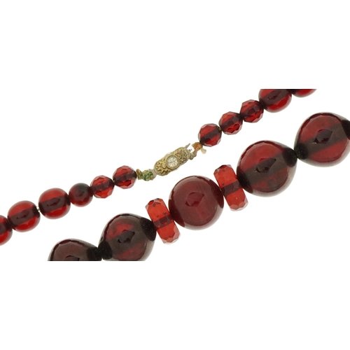 2116 - Cherry amber coloured bead necklace with clear stone clasp, the largest beads approximately 1.7cm wi... 