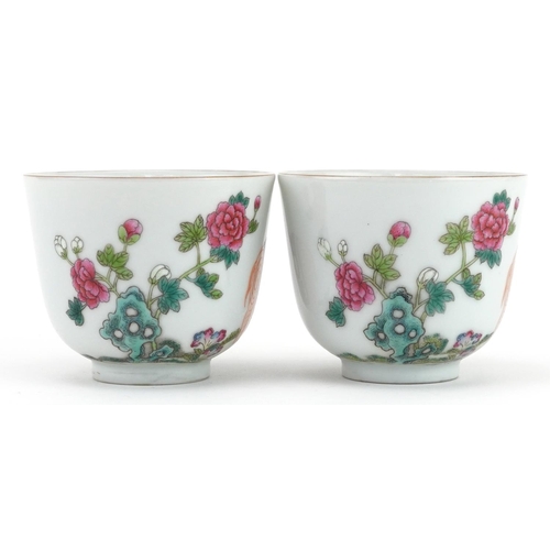 1828 - Pair of Chinese porcelain tea bowls hand painted in the famille rose palette with elephants in a lan... 