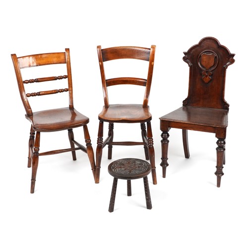 1037 - Antique occasional furniture comprising three chairs and a carved oak three footed stool, the larges... 