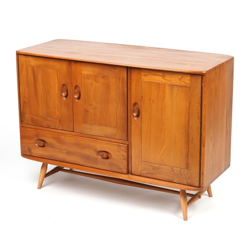 1031 - Ercol Windsor light elm sideboard fitted with three cupboard doors and drawer, 81.5cm H x 114cm W x ... 