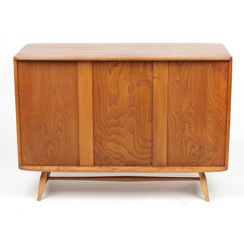 1031 - Ercol Windsor light elm sideboard fitted with three cupboard doors and drawer, 81.5cm H x 114cm W x ... 