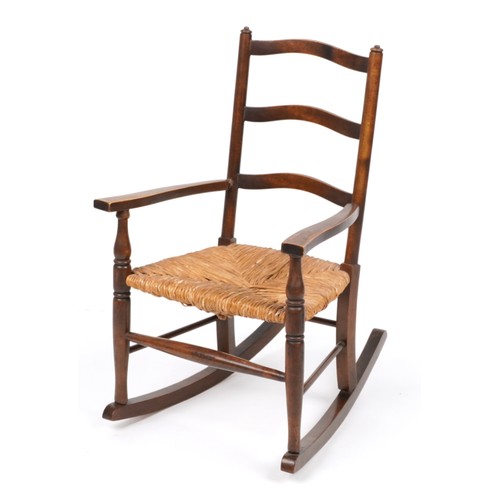 1040 - Antique mahogany childs rocking chair with rush seat, 67cm high