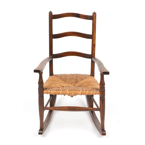 1040 - Antique mahogany childs rocking chair with rush seat, 67cm high