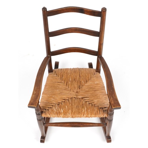 1040 - Antique mahogany childs rocking chair with rush seat, 67cm high