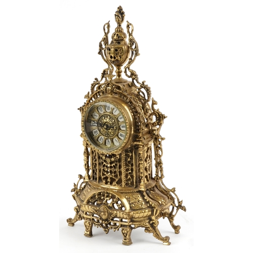 297 - Gothic style ornate brass mantle clock with circular dial having Roman numerals, 49cm high