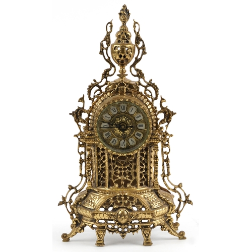 297 - Gothic style ornate brass mantle clock with circular dial having Roman numerals, 49cm high