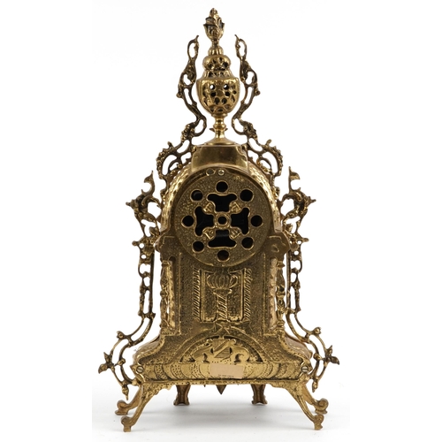 297 - Gothic style ornate brass mantle clock with circular dial having Roman numerals, 49cm high