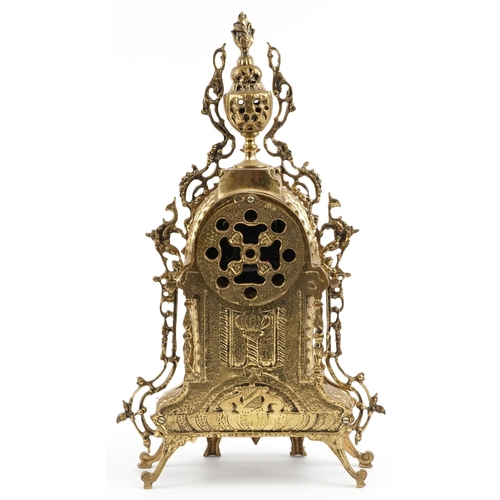 297 - Gothic style ornate brass mantle clock with circular dial having Roman numerals, 49cm high