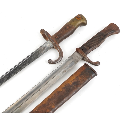 1415 - German military World War II sawback bayonet with scabbard by J H Becker and a French bayonet, the l... 