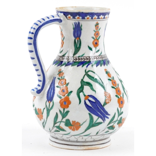 92 - Turkish Ottoman Iznik water jug hand painted with flowers, 22.5cm high