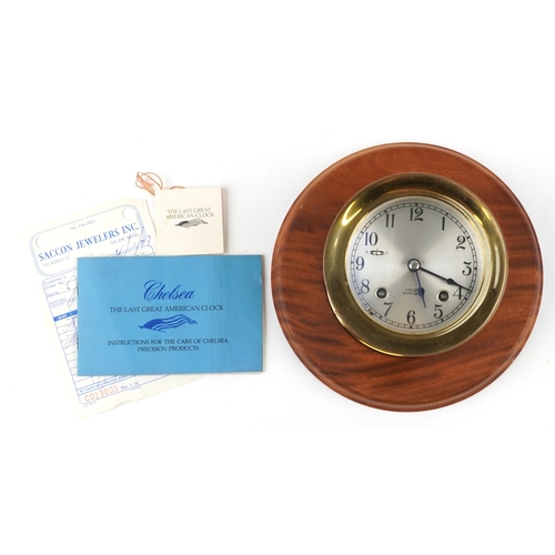 625 - Chelsea ship's bell brass bulkhead design wall clock with hardwood back and related paperwork, the b... 