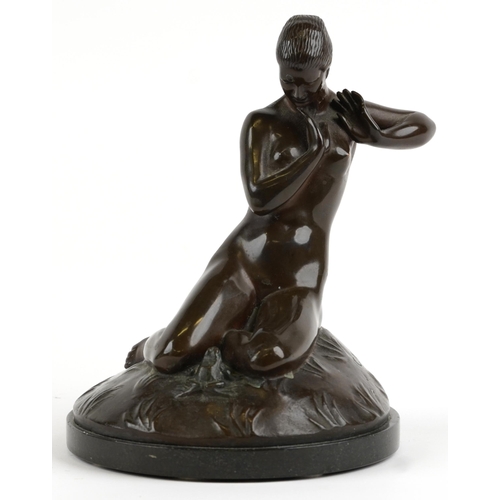 Carl Neuhaus 1921, German Art Deco patinated bronze statuette of a nude female with frog, raised on a circular marble base, 20cm high