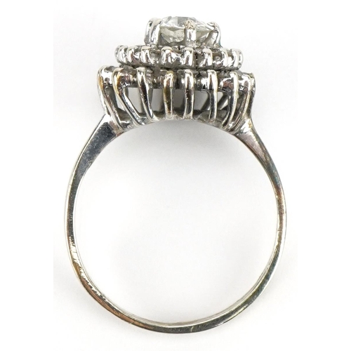 36 - Unmarked white gold diamond three tier cluster ring, the central diamond approximately 0.65 carat, s... 