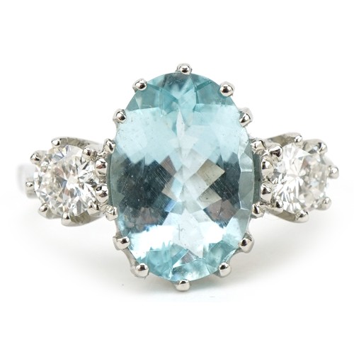 25 - Unmarked white gold aquamarine and diamond three stone ring, tests as 18ct gold, total diamond weigh... 