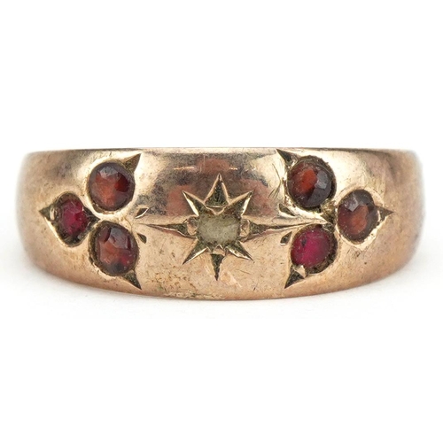 505 - 9ct rose gold garnet and diamond seven stone ring, size N, 1.9g