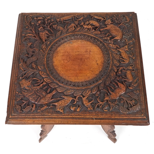 2031 - Anglo Indian hardwood folding side table, finely and deeply carved with an elephant and wild animals... 