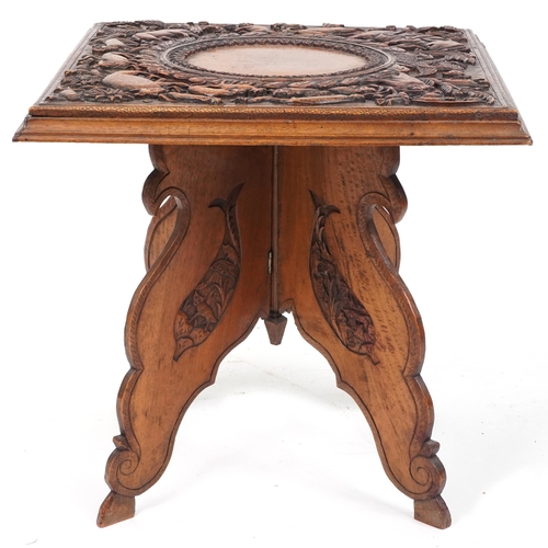 2031 - Anglo Indian hardwood folding side table, finely and deeply carved with an elephant and wild animals... 