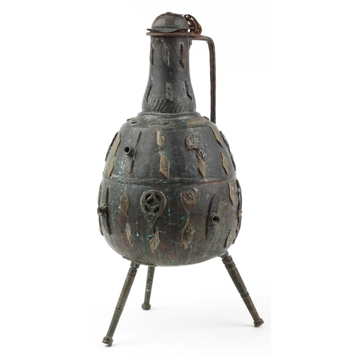 2440 - Large Middle Eastern patinated bronze three footed handled vessel, 64cm high