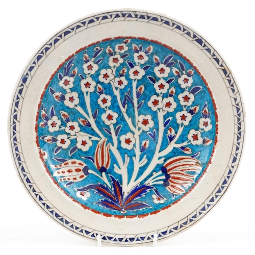 275 - Turkish Ottoman Iznik footed dish hand painted with flowers, 31cm in diameter