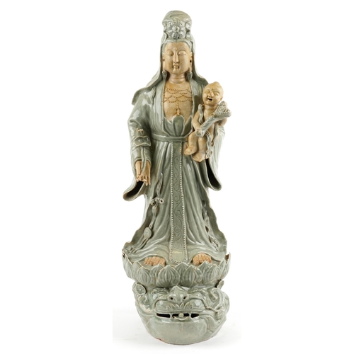 521 - Large Chinese porcelain figure of Guanyin holding a baby with ruyi sceptre, having a celadon glaze, ... 