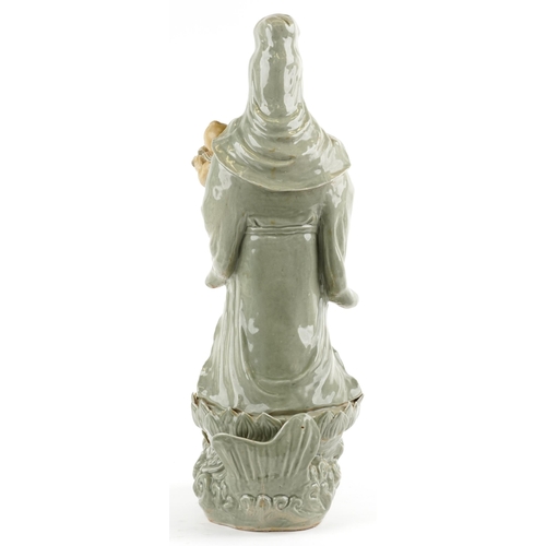 521 - Large Chinese porcelain figure of Guanyin holding a baby with ruyi sceptre, having a celadon glaze, ... 